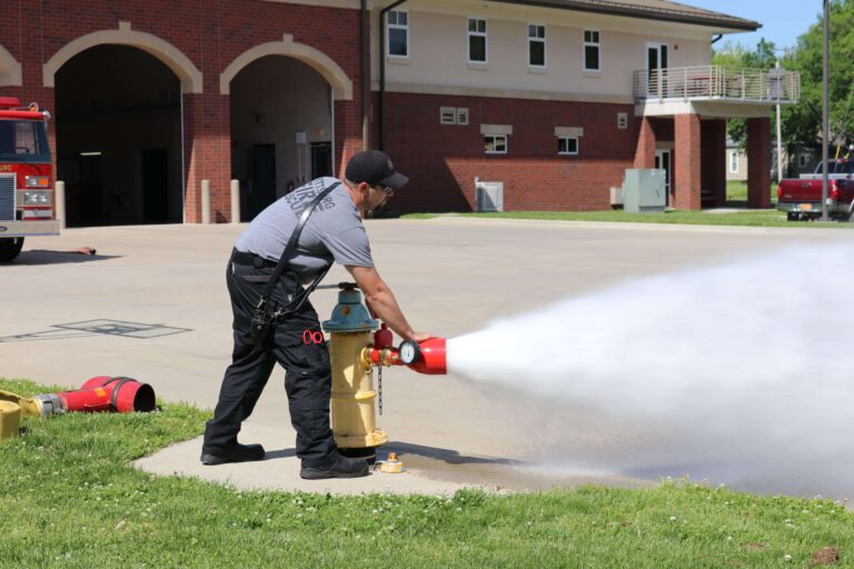 A Pittsburg Fire Department Firefighter flushes a hydrant in Pittsburg, KS.