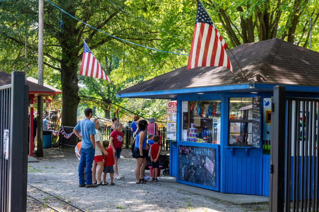 Group of people standing at a ticket stand waiting to purchase tickets at Kiddieland in Pittsburg, KS