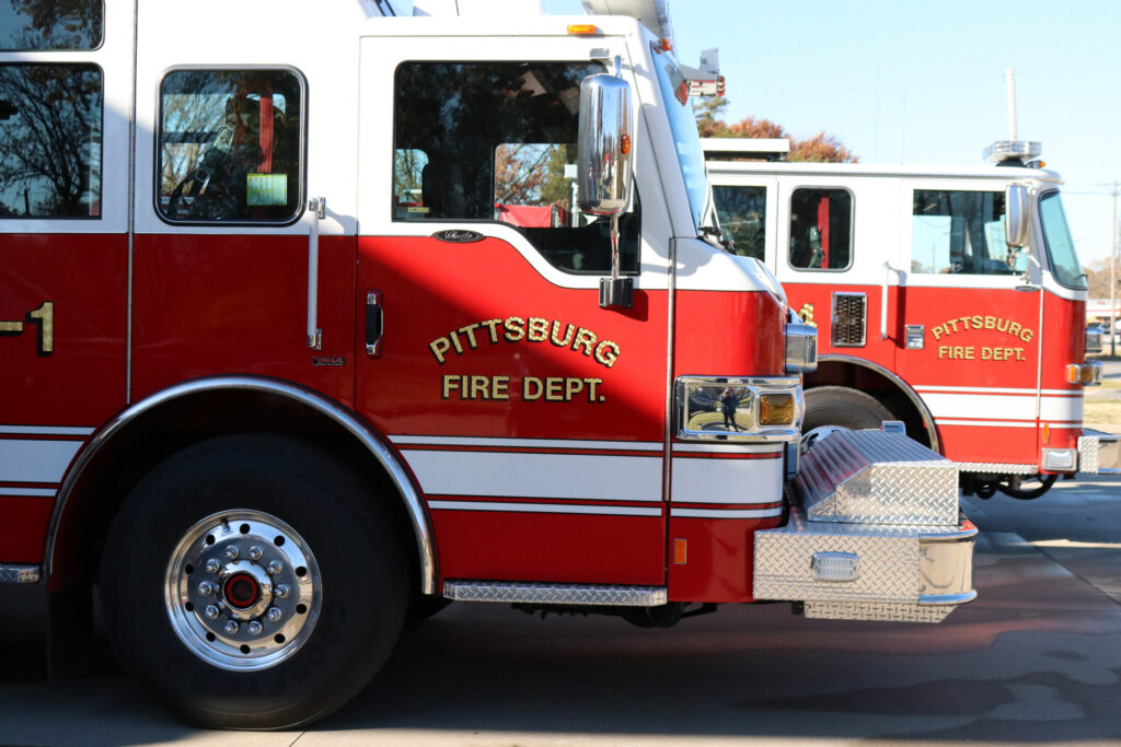 Two City of Pittsburg fire trucks viewing the front of each from the passenger side.
