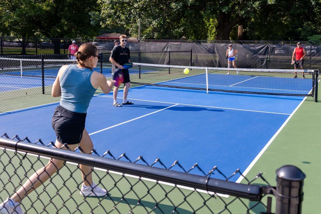 Adults playing Pickleball at the Johnson Pickleball Court in Pittsburg, Kansas.